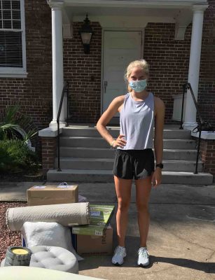 Grace Asleson stands next to her belongings outside Chaudoin Hall.
