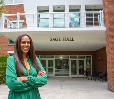 Bonita Dukes stands in front of Sage Hall 