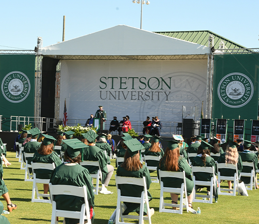 Graduates gather on the field for Commencement 2021, for Year in Review