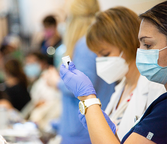 Nurses work at an on-campus vaccination clinic.