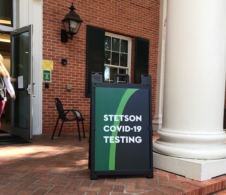 A sign outside the CUB announces COVID testing.